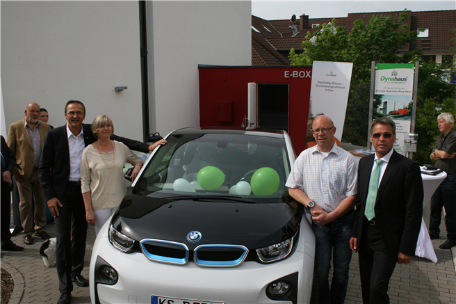 Testfamilie Freitag an ihrem neuen E-Auto, übergeben durch Matthias Krieger (Dynahaus) und Gotthold Heim (BMW) vor der E-Box inkl. E-Ladestation. © Dynahaus GmbH & Co. KG 